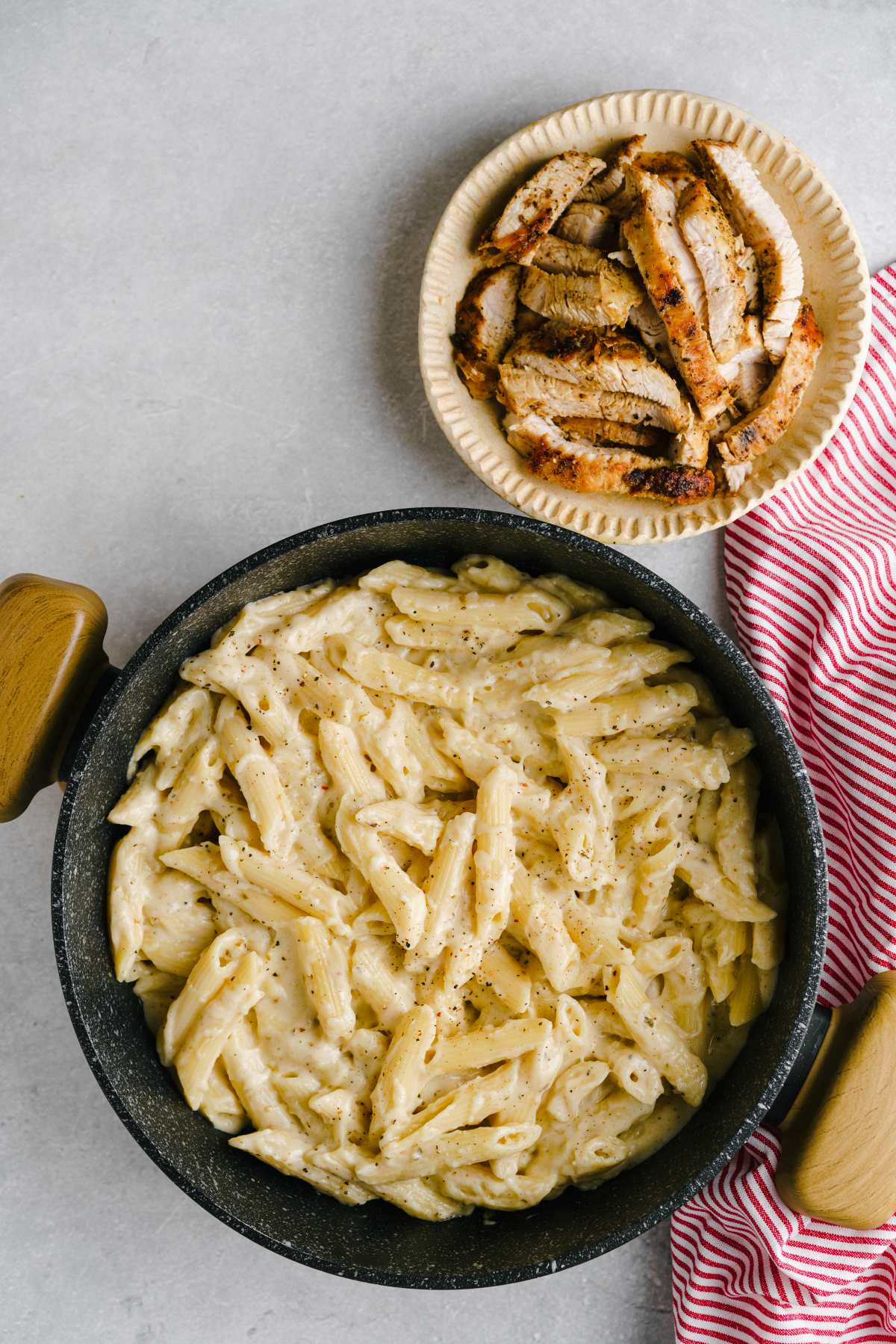 Creamy Parmesan Pasta in a bowl with chicken in a separate bowl.
