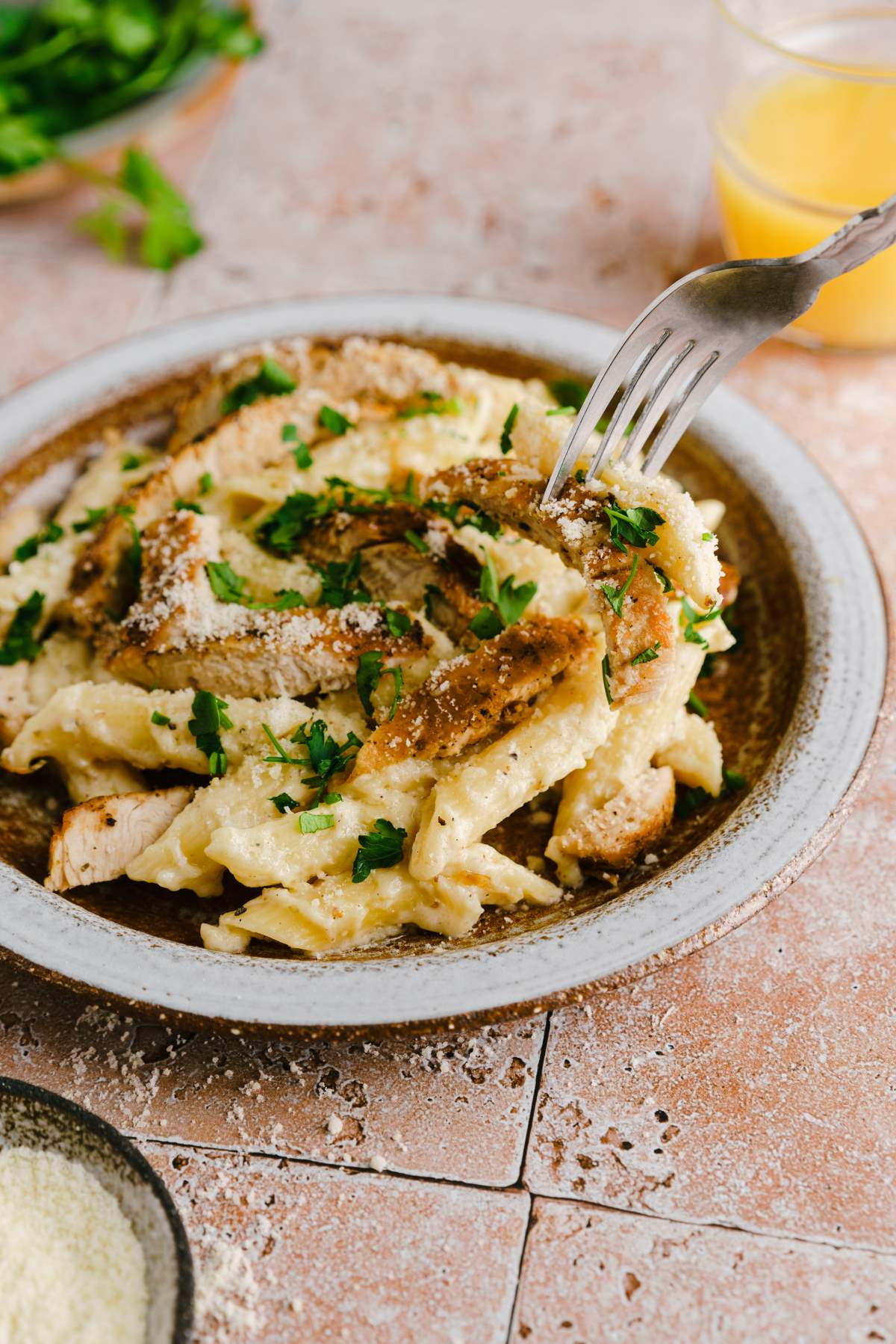 Garlic Chicken parmesan pasta in a bowl topped with parsley.