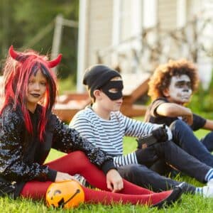 Children outside in spooky Halloween Costumes.