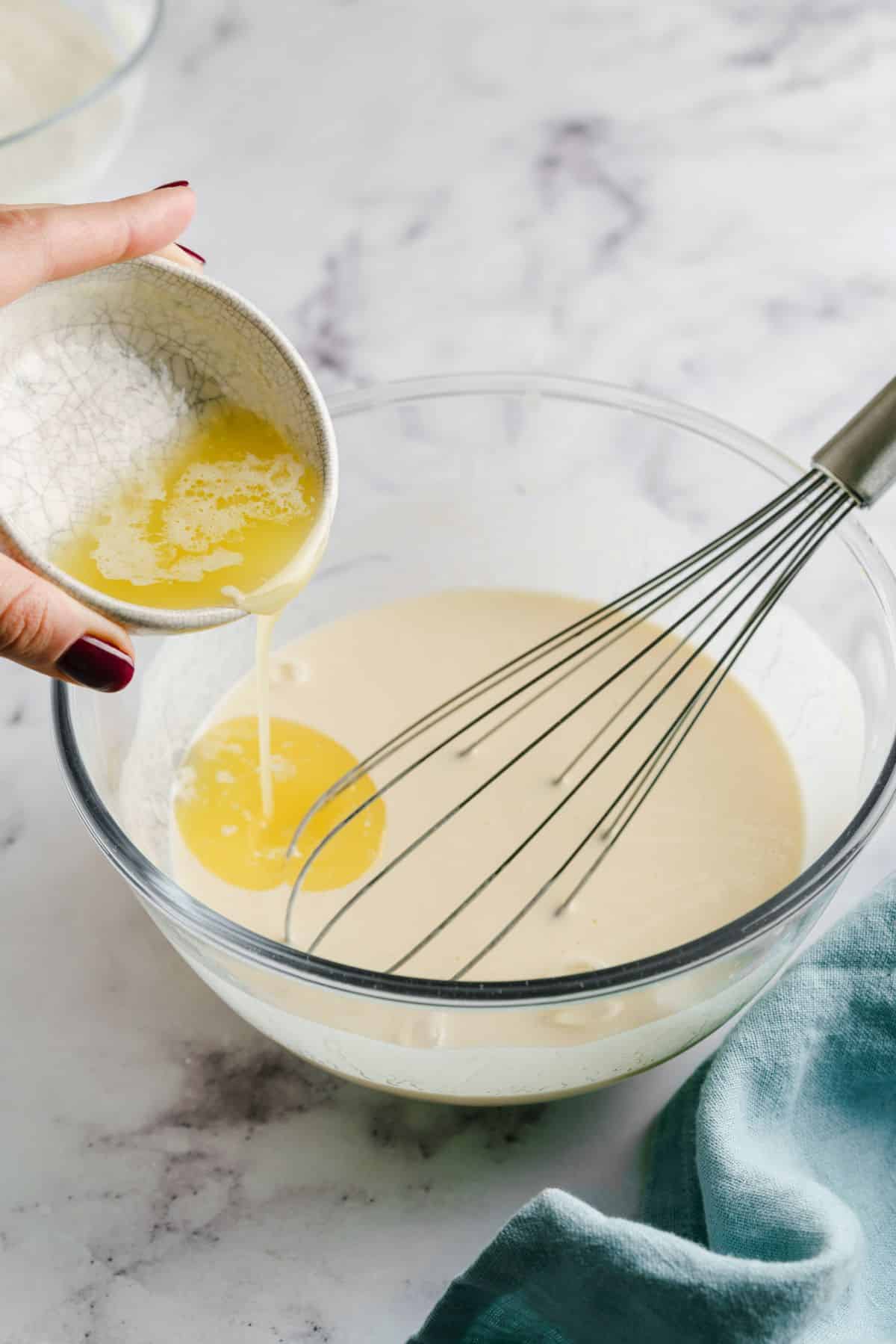 melted butter being added to pancake batter.
