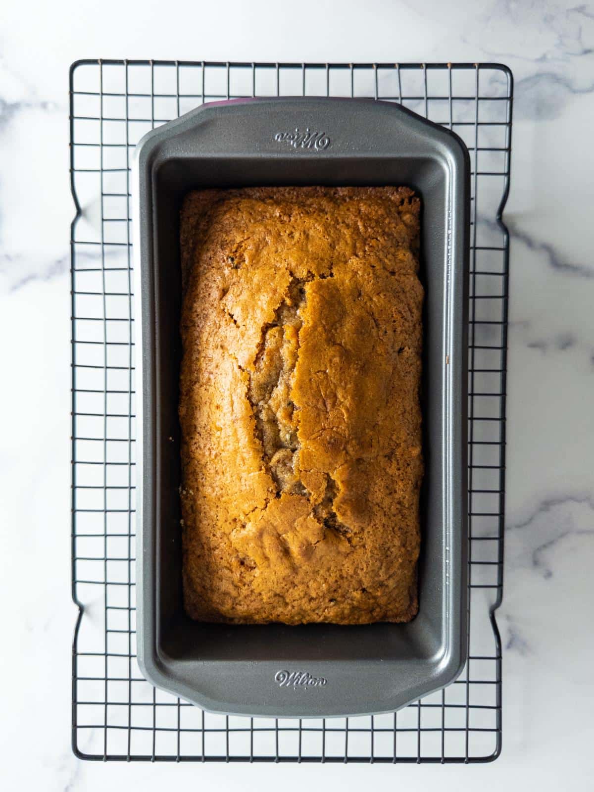 Baked zucchini bread in a loaf pan.