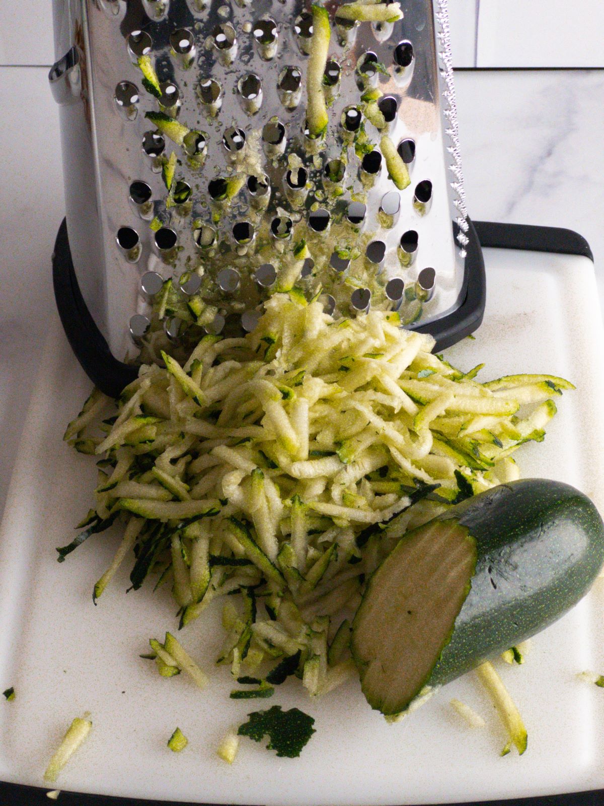 A zucchini being grated.