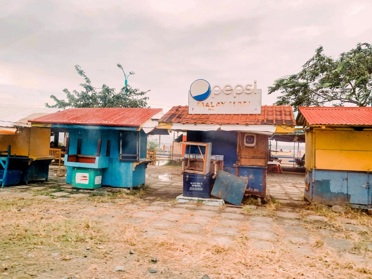 A deserted street with empty vendors.