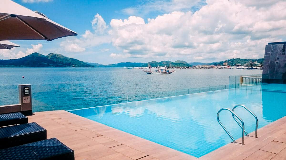 The bright blue clear waters of the infinity pool at the Two Seasons Bayside hotel in Coron Palawan.