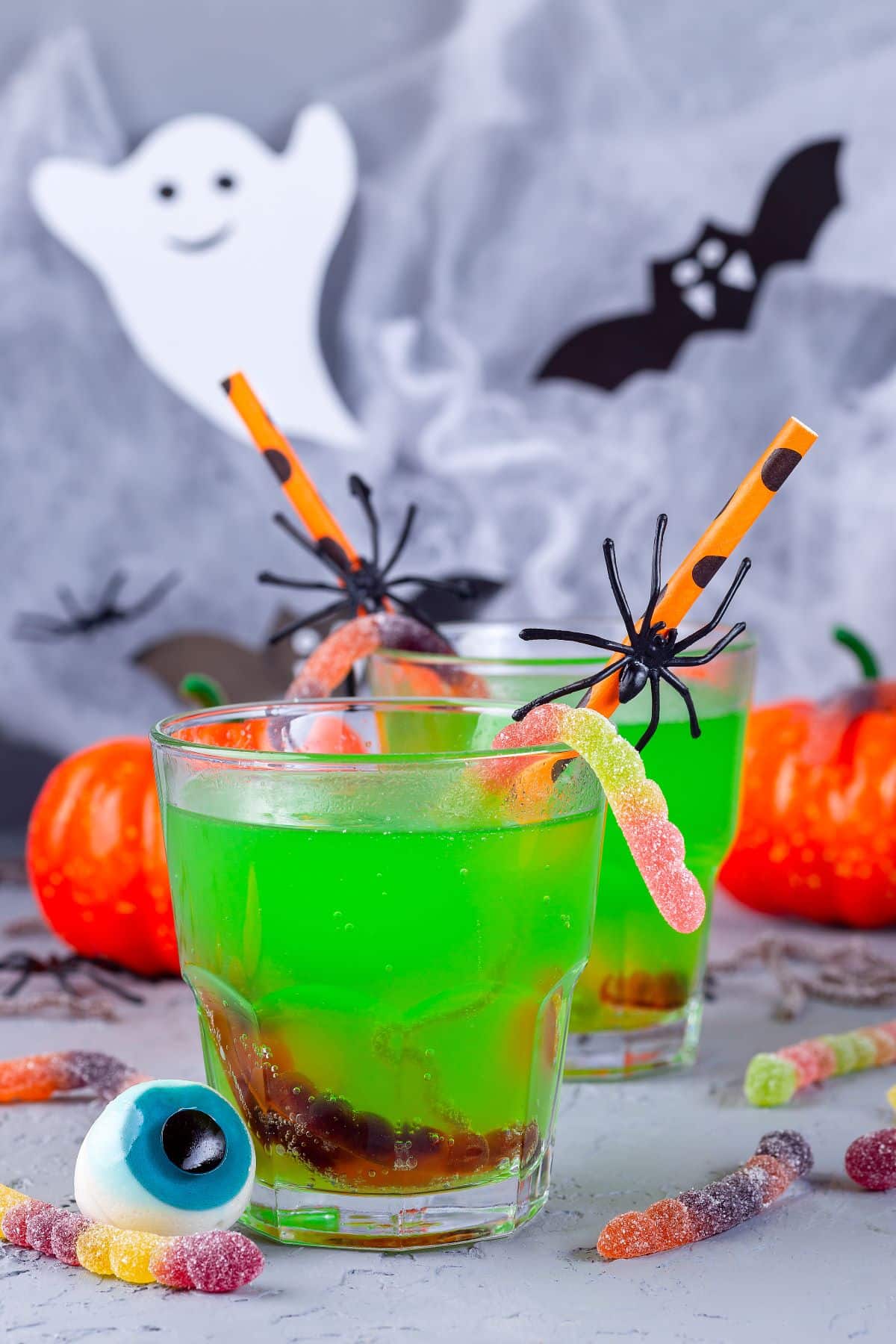 Green Halloween Drinks with gummy worms.