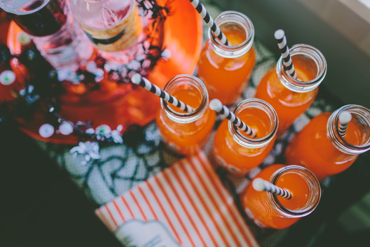 Several orange cocktails with halloween straws.