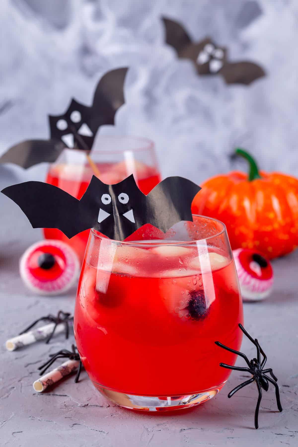 Red halloween cocktails with lychee eyballs.