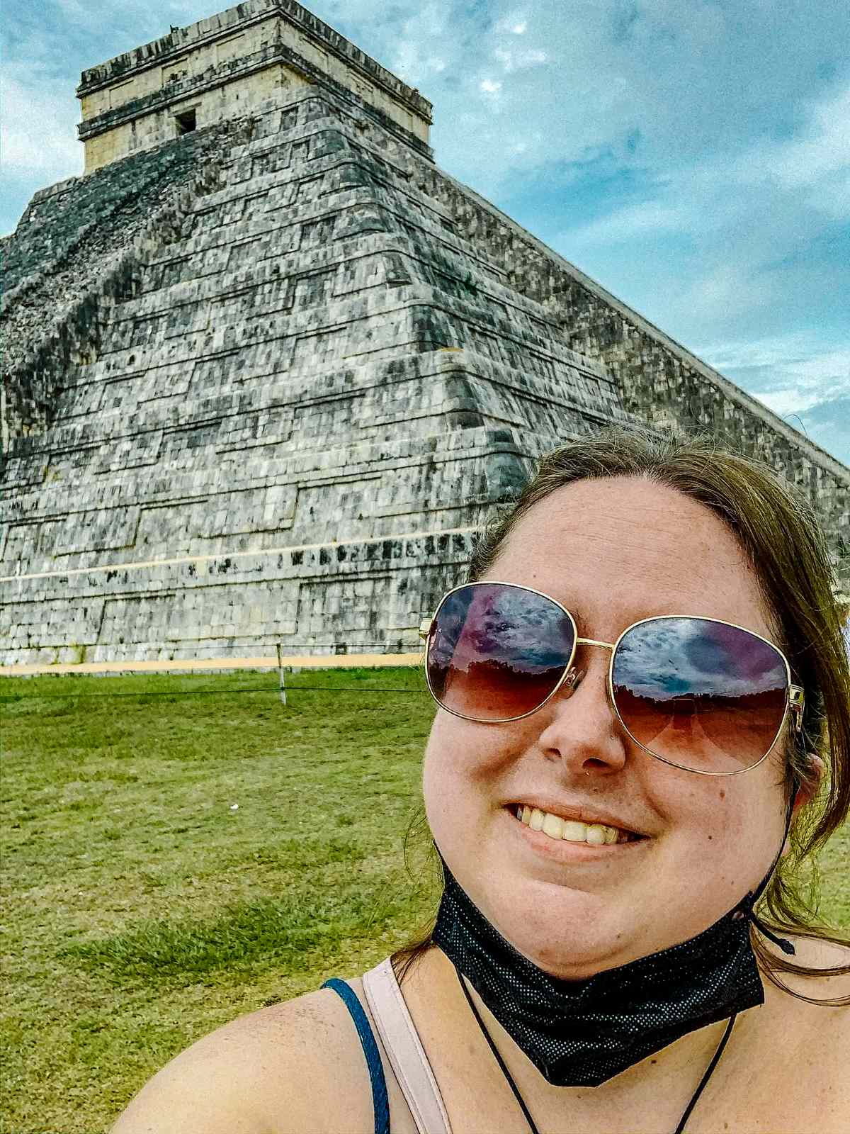 The blog author on a tour in front of a beautiful structure at Chichen Itza.