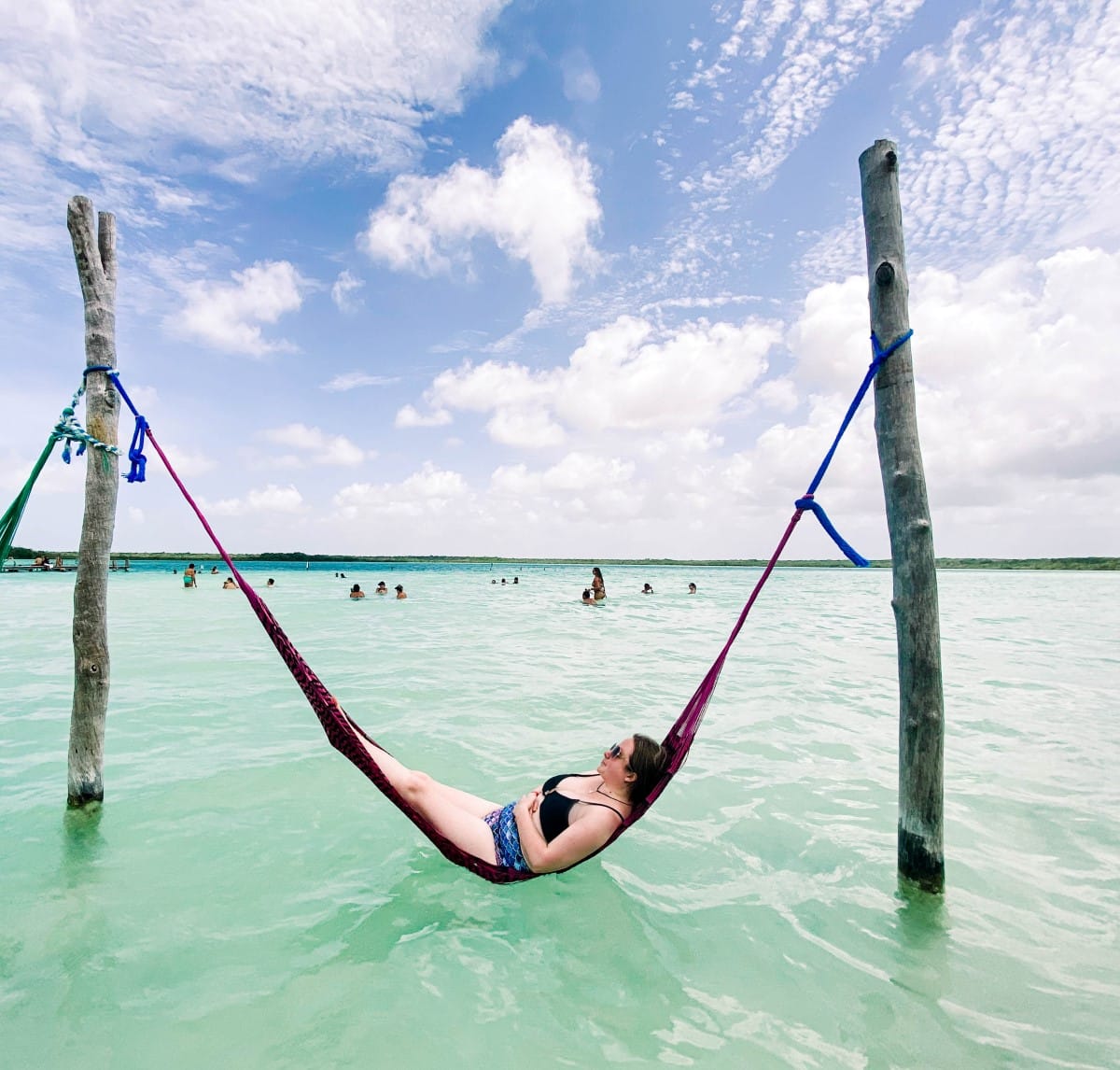 The blog author on a water hammock in the kaan luum lagoon.