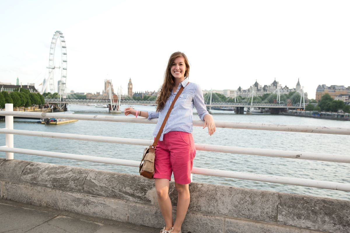 A female student studying abroad in london on a bridge.